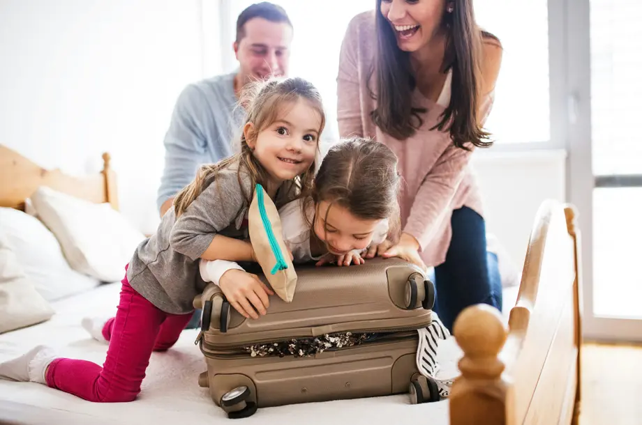 Family playing with suitcase